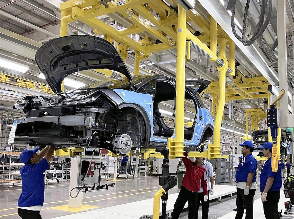 Workers assemble an electric vehicle at the BYD factory in Rayong, Thailand (Image: Yomiuri Shimbun / Associated Press / Alamy)