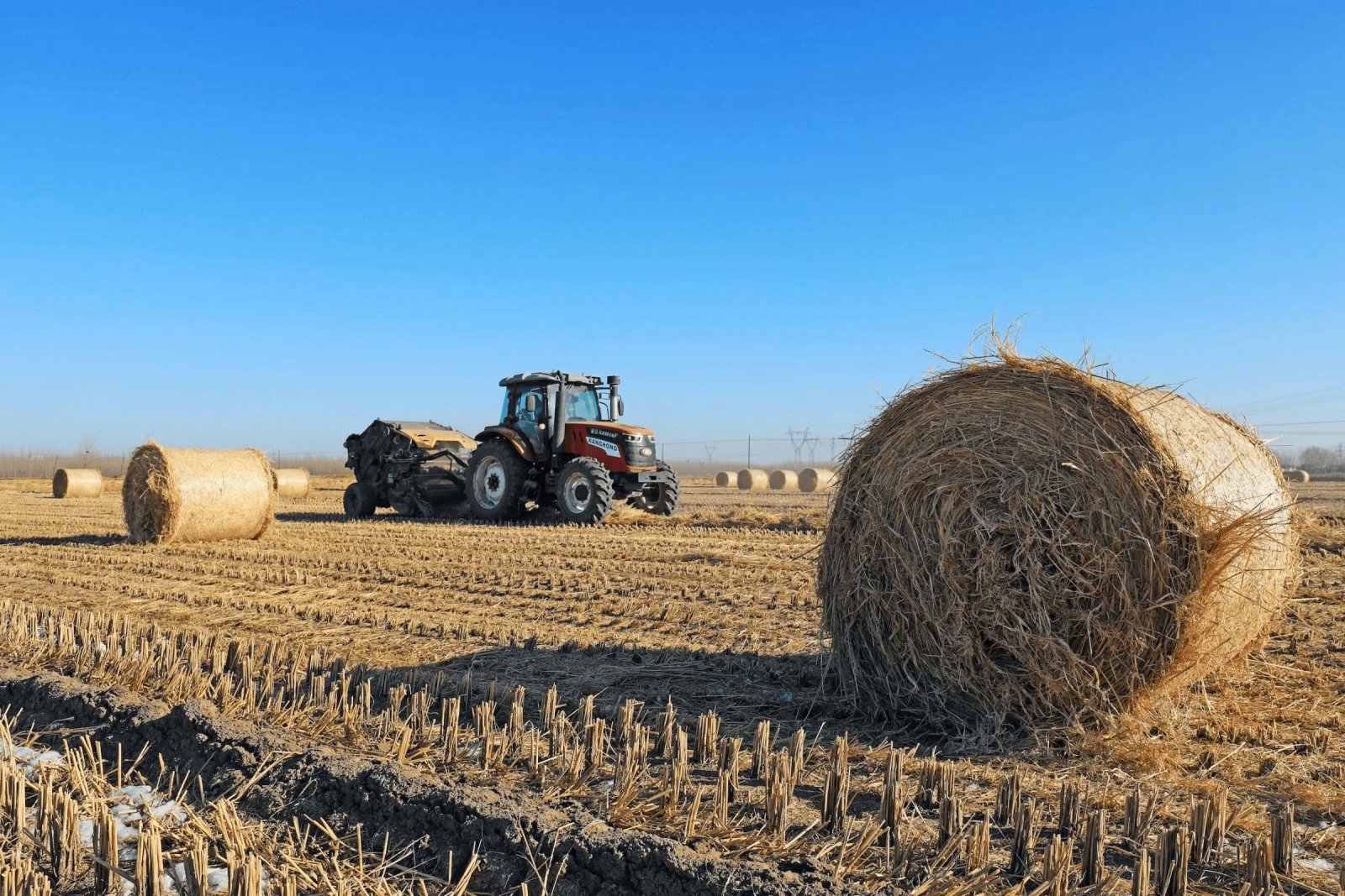 A farmer creates bales from leftover straw following the harvest in north China’s Hebei province. Biochar made from agricultural residues like this is a mature technology that could help remove CO2 from the atmosphere