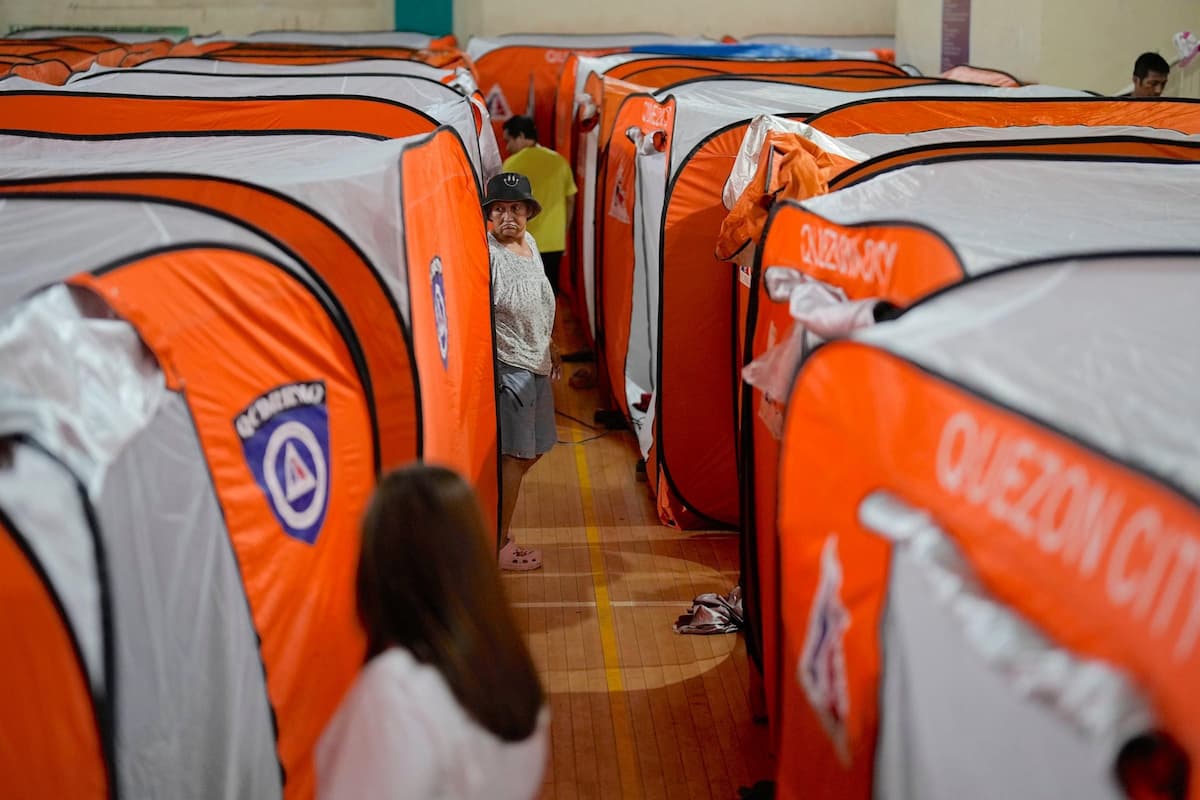 Evacuees with their tents at an evacuation centre in Quezon City, Philippines, as Super Typhoon Uwan hit the country in early November 2025 (Image: Aaron Favila / Associated Press / Alamy)