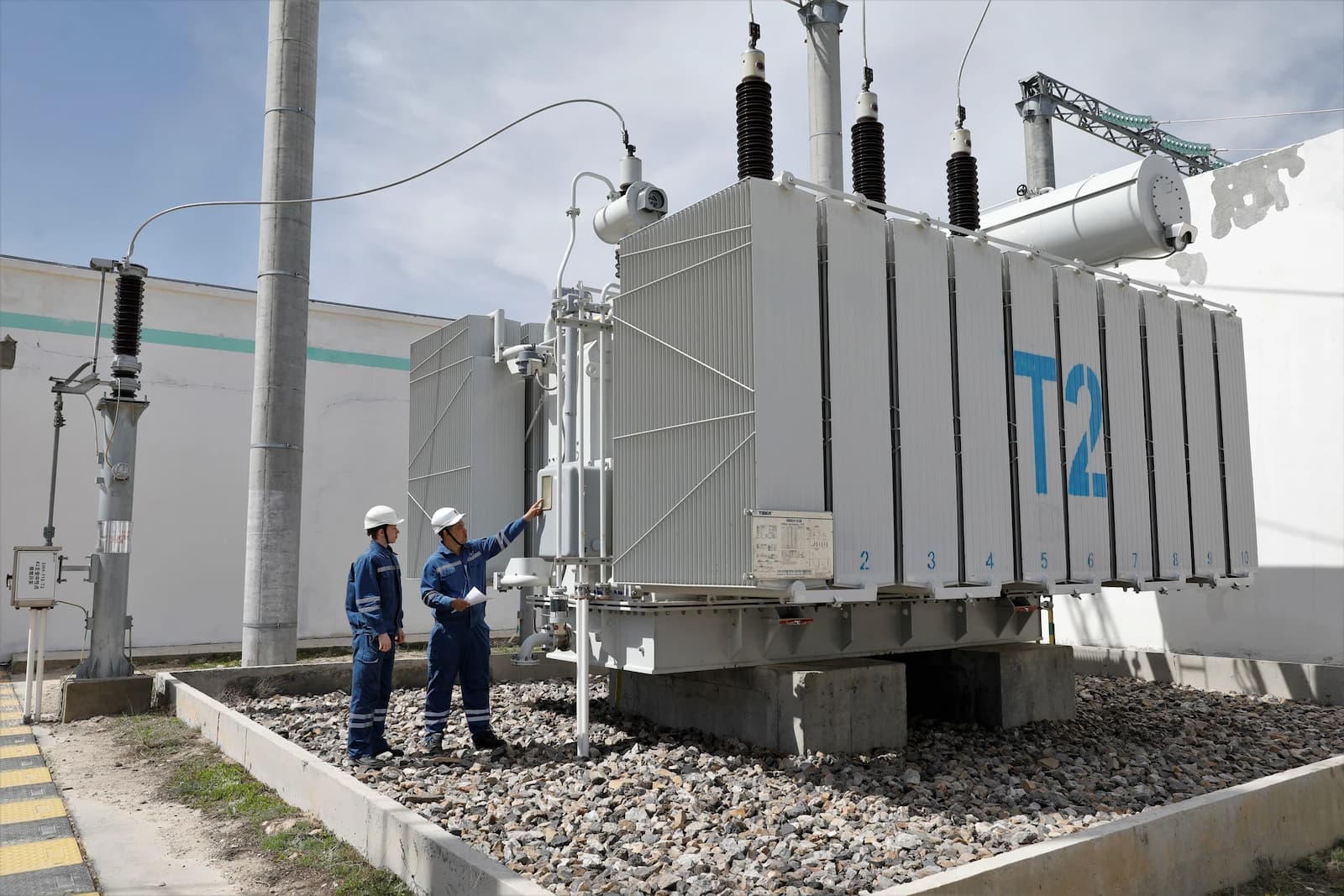 Workers check power transformer equipment at a wind farm in Zhanatas, Kazakhstan, a green energy project constructed under the BRI. Green projects of this type are one of several that could be eligible for funding via the new sustainability bonds 