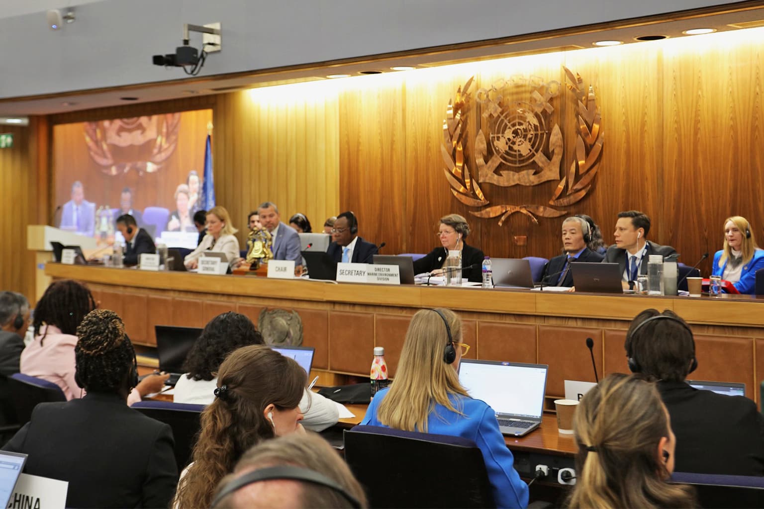 A meeting of the IMO’s Marine Environment Protection Committee (MEPC) in London in April. Member nations voted in favor of advancing a “net-zero framework,” a draft plan to gradually decarbonize the shipping industry. The next MEPC meeting, at which the framework could be adopted, will be held in October. Image by IMO via Flickr (CC BY 2.0).